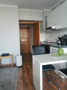 a kitchen with white cabinets and a counter top at Lieblingsstrand App20 Maritim Residenz in Travemünde
