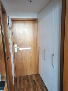 a wooden door in a room with a hallway at Lieblingsstrand App20 Maritim Residenz in Travemünde +17 photos