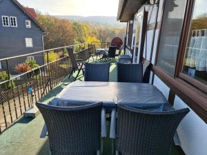 a porch with a table and chairs on a balcony at EderseeGlück - Fewo 2 in Edertal +3 photos