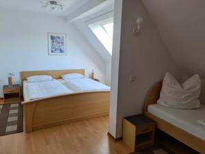 a bedroom with two beds with white sheets and a window at EderseeGlück - Fewo 2 in Edertal