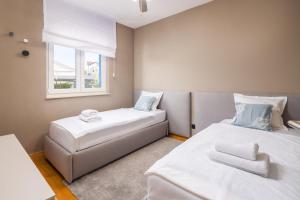a bedroom with two beds and a window at ZK luxury Villa in Murter +31 photos