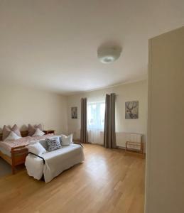 a large bedroom with a bed and a couch at Rohrbruch in Lansen