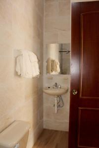 a bathroom with a sink and a toilet at Posada San Jorge in Cuetzalán del Progreso
