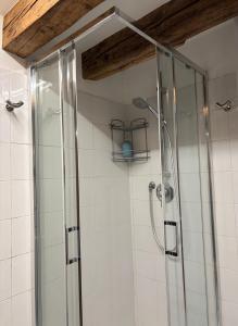 a shower with a glass door in a bathroom at San Marco Loft in Venice