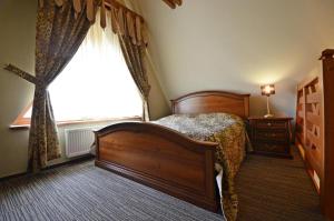 Cama o camas de una habitación en Pensjonat Nad Rzeką