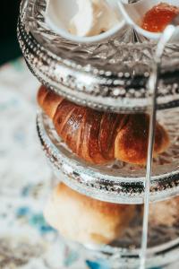 a three tiered plate of pastries on a table at Trovador Guest House in Guimarães