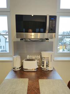 a kitchen with a counter with a microwave and appliances at Ferienwohnung Gebauer in Görlitz +17 photos