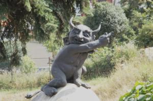 a statue of a devil sitting on a rock at Harzhaus in Wienrode
