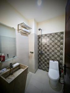 a bathroom with a toilet and a sink and a mirror at hotel Elites Residency , iqbal town in Lahore