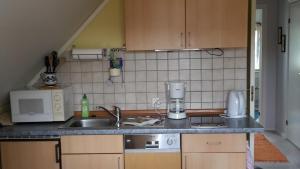 a kitchen with a sink and a counter top at Fewo im "Schwedenhaus" in Prerow +4 photos