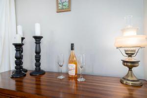 een tafel met twee glazen en een fles wijn bij Historic 5BDR Orchard Home in Suttons Bay