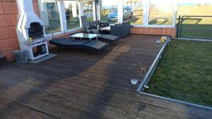 a patio with chairs and a table and a fireplace at Bungalow, Altwarp , Meerblick,Hund darf mit in Altwarp