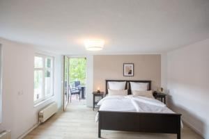 a bedroom with a large bed and a window at Apartment No6 in Stralsund