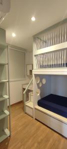 a bedroom with a bunk bed and a staircase at Comforto a Beira-Mar com Vista Deslumbrante in Barra Velha