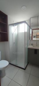 a bathroom with a glass shower and a toilet at Comforto a Beira-Mar com Vista Deslumbrante in Barra Velha