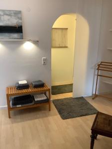 a living room with a table and a hallway at Hanni und Nanni in Haldenwang