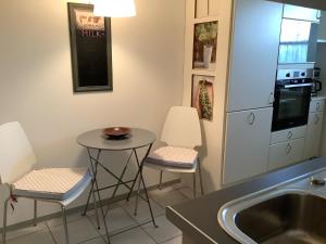 a kitchen with two stools and a table and a sink at Hanni und Nanni in Haldenwang +8 photos