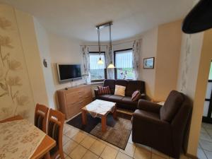 a living room with a couch and a table at Eifel Ferienwohnung Dahmen in Gerolstein