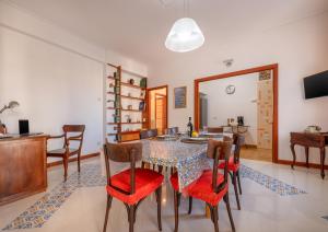 a dining room and living room with a table and chairs at Marziale Luxury Apartment in Sorrento