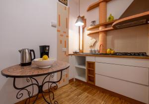 a kitchen with a counter with a bowl on a table at Marziale Luxury Apartment in Sorrento