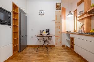 a small kitchen with a table in the middle at Marziale Luxury Apartment in Sorrento