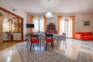 a living room with a dining room table and chairs at Marziale Luxury Apartment in Sorrento