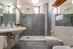 a bathroom with a shower and a toilet and a sink at Marziale Luxury Apartment in Sorrento +31 photos