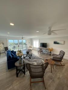 a living room with a blue couch and chairs at 8 Sea Front, Oceanfront Estate, Pool, Game Room, Elevator in Hilton Head Island