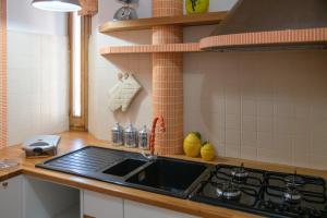 a kitchen with a sink and a stove at Marziale Luxury Apartment in Sorrento