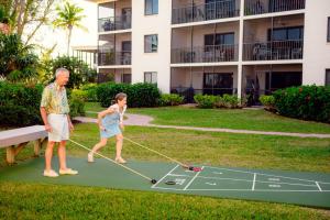 an older man and woman playing a game of miniature golf at 3rd story beach views Sandalfoot Condo on Sanibel Island 2A3 in Sanibel