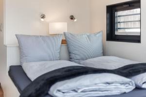 a bedroom with two beds and a mirror and a window at Hausboot Chalet am Meer - LP8 in Peenemünde