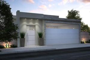 a building with two garage doors on a street at Mateus praia casa in Búzios