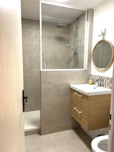 a bathroom with a shower and a sink and a mirror at Studio 4 people Stella beach in Cucq