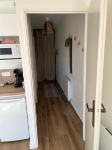 a hallway leading to a kitchen with a door open at Studio 4 people Stella beach in Cucq
