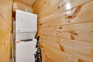 a washer and dryer in a tiny house at Honeybear Hideaways - Luxury Gatlinburg Smoky Cabin with Indoor Pool and Hot Tub in Gatlinburg