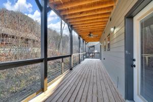an empty porch of a house with a wooden deck at Honeybear Hideaways - Luxury Gatlinburg Smoky Cabin with Indoor Pool and Hot Tub in Gatlinburg