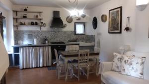 a kitchen and living room with a table and a couch at LA PAJARELLA di ZOER in Aielli
