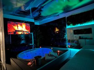 a bathroom with a tub with a fire in it at S O P H I A room by 50 shades in Baia Mare