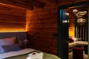 a bedroom with wooden walls and a mirror and a bed at Alm-Lodge 2 in Clausthal-Zellerfeld
