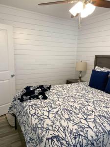 a bedroom with a bed with a cat on it at Coastal Condos on the Marsh 5A in Dauphin Island