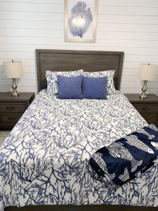 a bedroom with a bed with blue pillows and two lamps at Coastal Condos on the Marsh 5B in Dauphin Island +12 photos