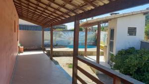 an outdoor patio with a view of a swimming pool at Alugo para Carnaval in Araruama