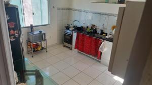 a kitchen with a sink and a stove top oven at Alugo para Carnaval in Araruama
