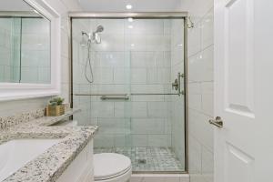 a bathroom with a shower with a toilet and a sink at 3rd Floor Sanibel Condo With Balcony And Beach Views 4B3 in Sanibel +13 photos