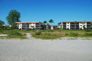 a view of two apartment buildings from the beach at Island retreat with stunning gulf views Sanibel Island 3A2 in Sanibel +2 photos