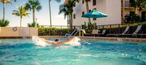 a person in the water in a swimming pool at Island retreat with stunning gulf views Sanibel Island 3A2 in Sanibel