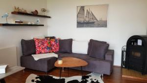 a living room with a couch and a table at Am Ufersteig-I in Verchen