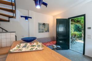 a kitchen with a wooden table with a blue bowl on it at Flairhouse Parco in Gravedona