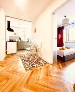 a living room with a bed and a wooden floor at Saltwater Apartment Gdynia in Gdynia