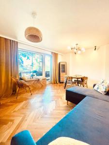 a living room with a couch and a table at Saltwater Apartment Gdynia in Gdynia